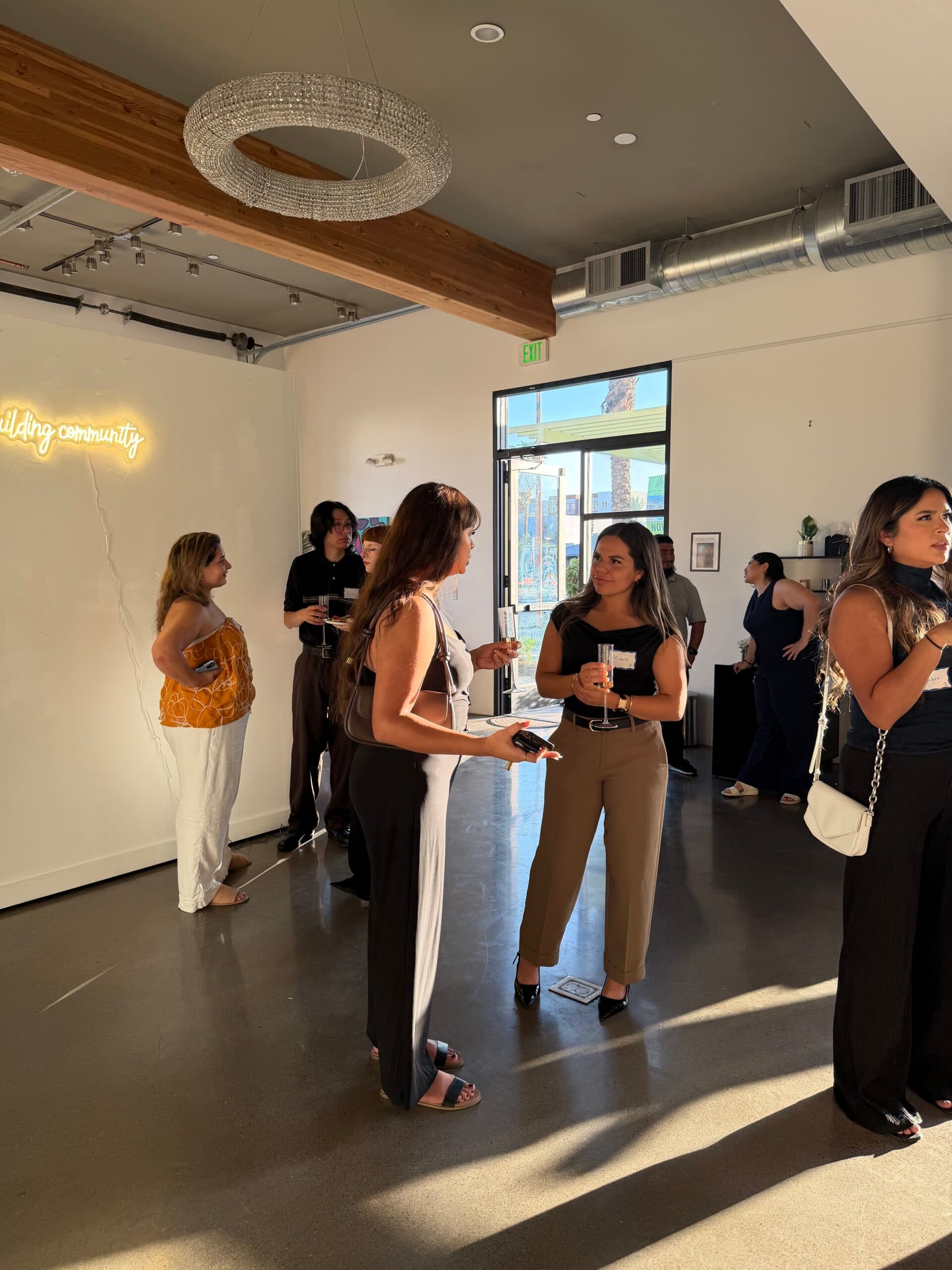 Guests talking in small groups at an evening gathering